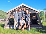 A group of boys pose in front of their Tent City tent.